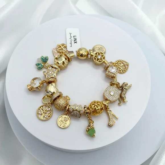Linx Yellow Gold Bracelet with Gold and Green Themed Charms